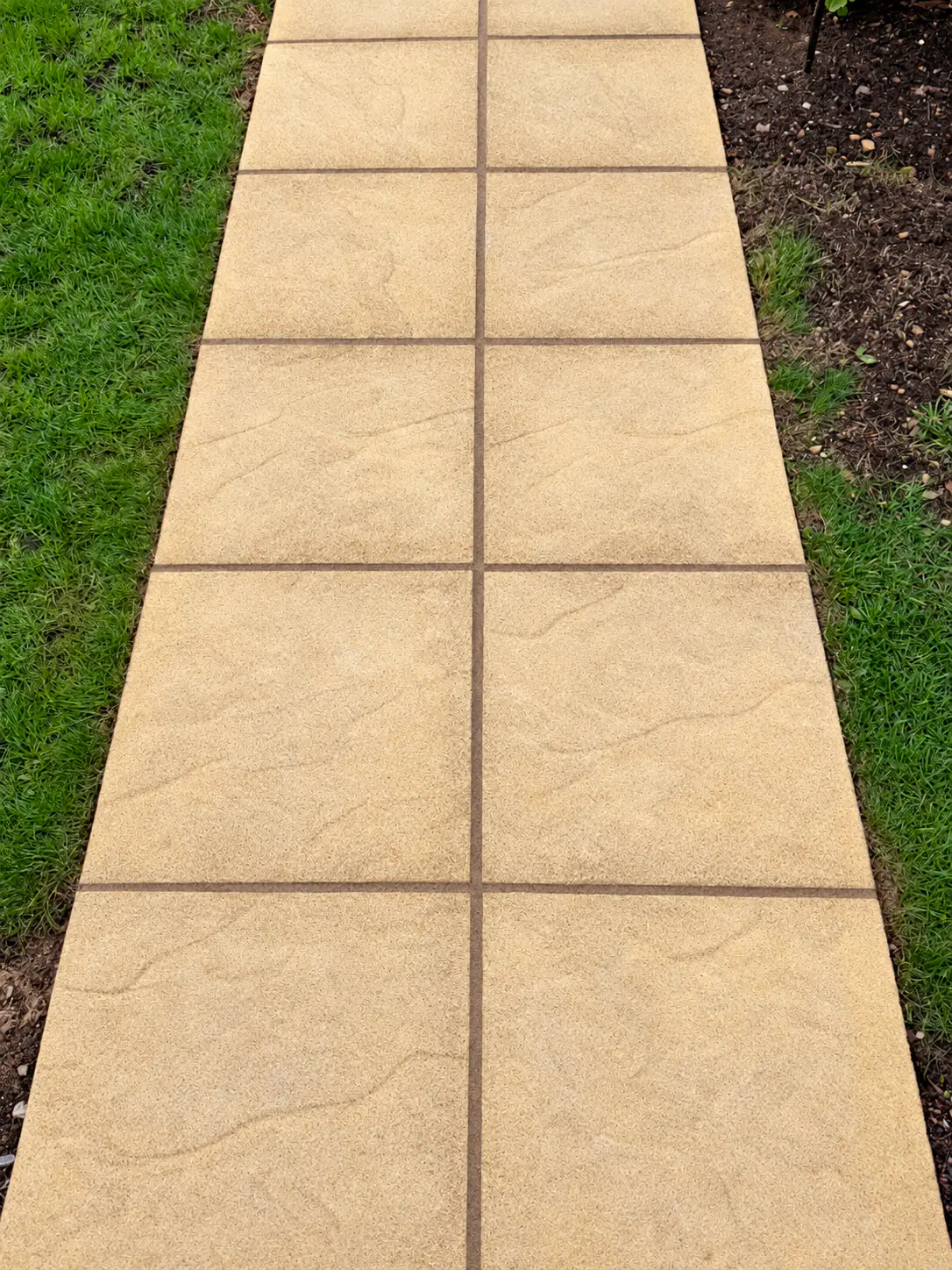 The same garden path after cleaning, the slabs back to an even sandstone colour