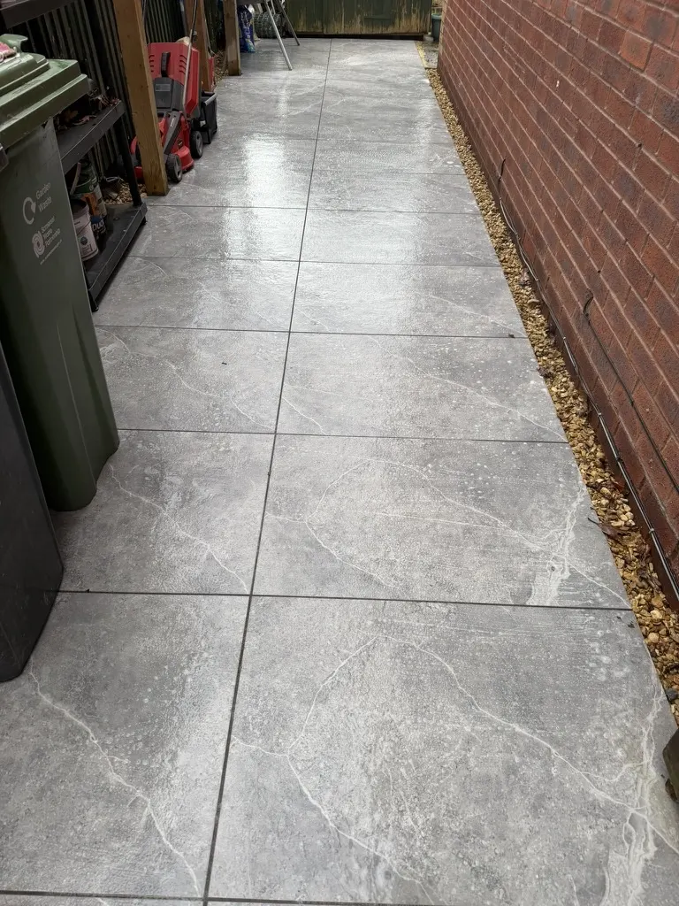A tiled path, clean and still wet after washing
